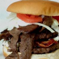 Greek Freak · Flame-grilled 1/3 lb burger topped with gyros slices, bacon, crumbled feta cheese, tomato, o...