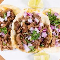 Street Tacos · Three tacos in corn tortillas, choice of grilled steak, chicken, al pastor, or carnitas. Wit...