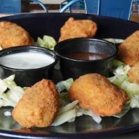 Jalapeño Poppers (8 Pieces) · Deep fried jalapenos stuffed with cream cheese.