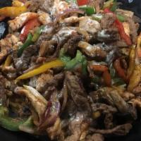 Lindo Special · Steak, shrimp, and chicken cooked with onions, belle peppers, and mushrooms. Served over a b...