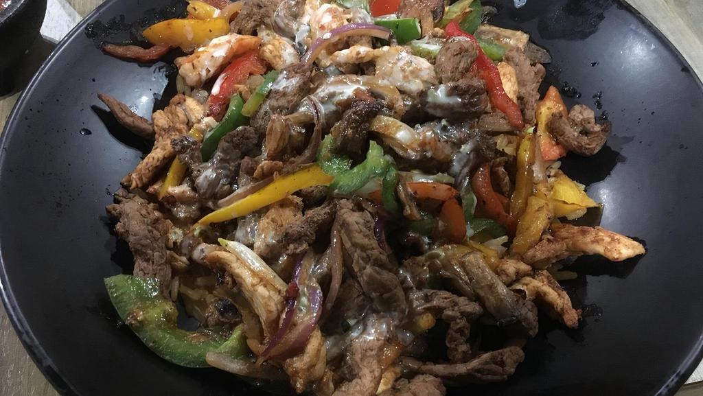 Lindo Special · Steak, shrimp, and chicken cooked with onions, belle peppers, and mushrooms. Served over a bed of rice covered with our delicious cheese sauce.
