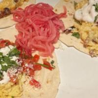 Breakfast Tacos · Three corn or flour tortillas filled with scrambled eggs, guacamole, cotija cheese, crème fr...