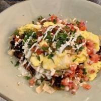 Huevos Rancheros · Corn tortilla layered with black beans, pepper jack cheese, guacamole, ranchero sauce, beef ...
