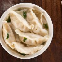 Jhol Momo · Hand-wrapped steamed dumplings made with a spiced meat filling topped with our signature spi...