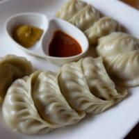 Chicken Momo · Hand-wrapped steamed dumplings made with a mildly spiced chicken filling.