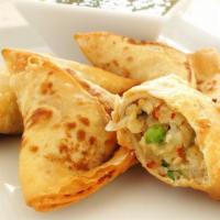 Vegetable Samosa · Fresh dough stuffed with potatoes and vegetables, deep-fried to perfection.