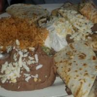 #1. Chicken Quesadillas · Two Flour tortillas stuffed with chicken and cheese. Includes lettuce, tomato, sour cream, r...