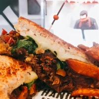 Brisket Grilled Cheese  · Braised brisket, cheddar cheese, provolone cheese, muenster cheese, peppadew peppers, carame...