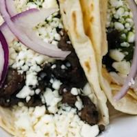 Steak Taco · Grilled steak, queso fresco, homemade chimichurri and red onions served on flour tortilla.