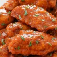 Buffalo Wings · Wings lightly fried, tossed in Buffalo sauce, served with ranch dressing.