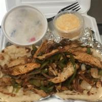 Chicken Fajita Dinner · 2 grilled chicken breasts, sauteed peppers & onions, shredded cheese, rice, 2 pitas & sour c...