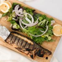 Levrek (Grilled Whole Fish) · Bronzini is grilled over an open flame, and served with a mixed green salad and rice pilaf.