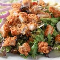 Brew Pub Salad · A bed of field greens topped with tomatoes, shredded carrots, diced red onions and herbed cr...