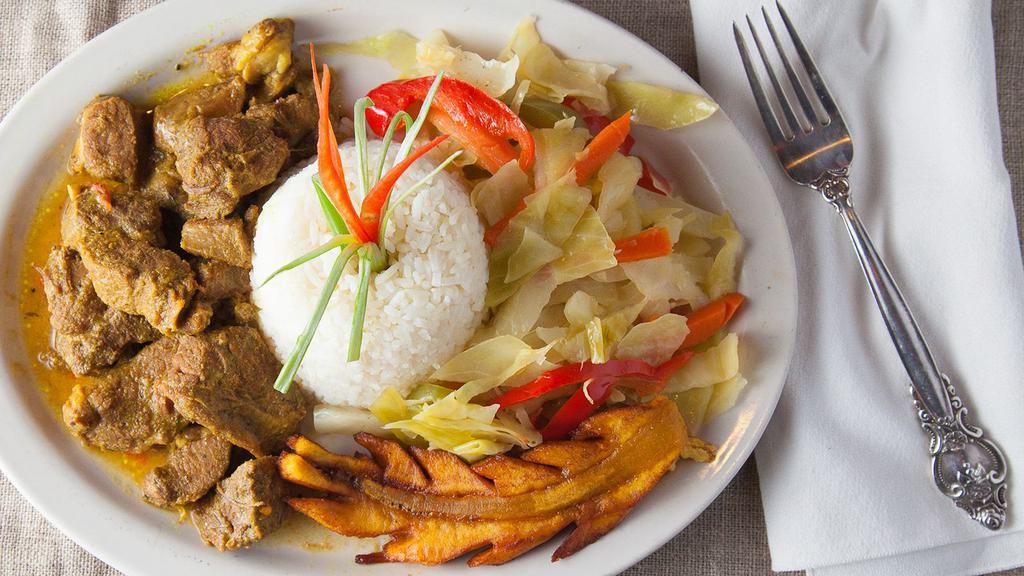 Curry Goat Dinner · Served with your choice of rice and your choice of side.