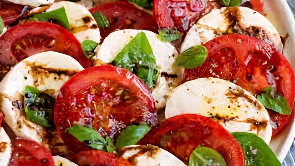 Caprese · Sliced roma tomatoes bedded with fresh mozzarella and basil, then drizzled with extra virgin olive oil and balsamic reduction. Vegetarian. Gluten free.