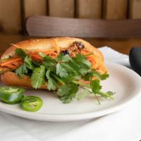 Banh Mi · Sour pickled daikon, sweet carrots, crisp cilantro, cucumber and spicy chilis on a baguette....