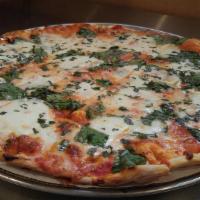 Margherita Pizza · Whole crushed tomatoes on a thin crispy crust topped with fresh creamy mozzarella and basil....