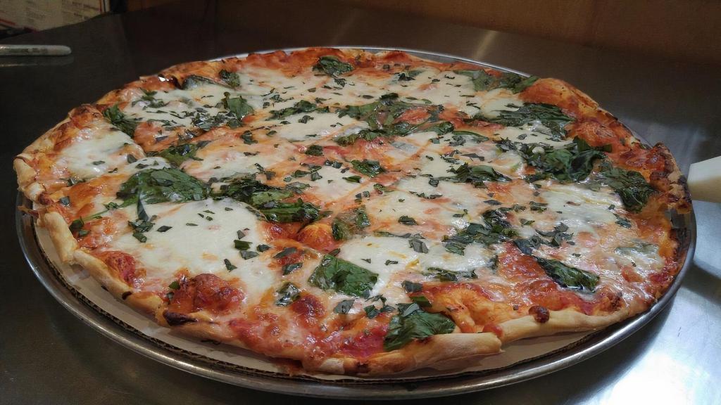 Margherita Pizza · Whole crushed tomatoes on a thin crispy crust topped with fresh creamy mozzarella and basil. Served with thin crust.