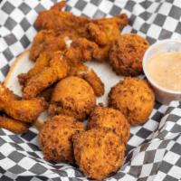 Catfish Nuggets · Catfish nuggets served with hush puppies and comeback sauce.