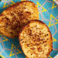 Garlic Bread · Baked Portuguese roll smothered in garlic-herb butter and grilled.