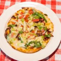 Philly Steak Pizza · Steak, Swiss, mozzarella, green pepper, onions, lettuce, and tomato, mixed in Greek dressing...