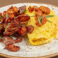 Omelet · Over roasted tomatoes, chevre, tarragon, breakfast potatoes.