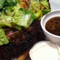 Prime Rib Sandwich · Tender prime rib on a toasted ciabatta roll topped with a caesar salad.