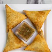 Sambusa (Lentil) · Fried sambusas filled with lentils and spices. Served with house-made spicy dipping sauce.