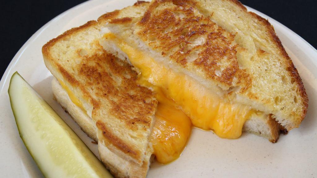 Ultimate Grilled Cheese · American, swiss & cheddar on our sourdough.