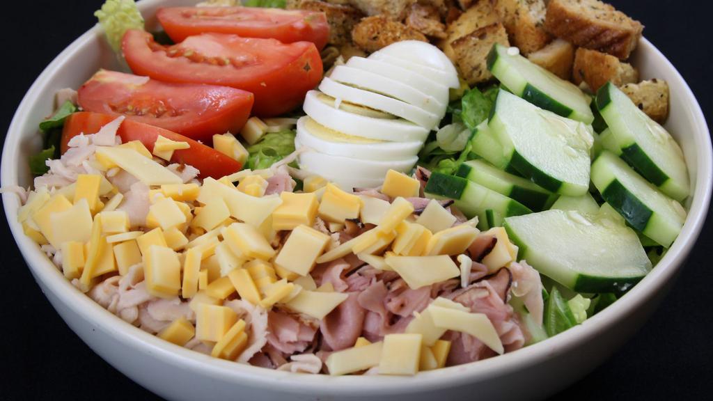 Chef Salad · Greens, turkey, ham, hard-boiled egg, cheddar, tomatoes, cucumbers, croutons.