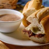 French Dip · Thinly sliced Roast Beef topped with swiss & baked on a Italian loaf. Served with a side of ...