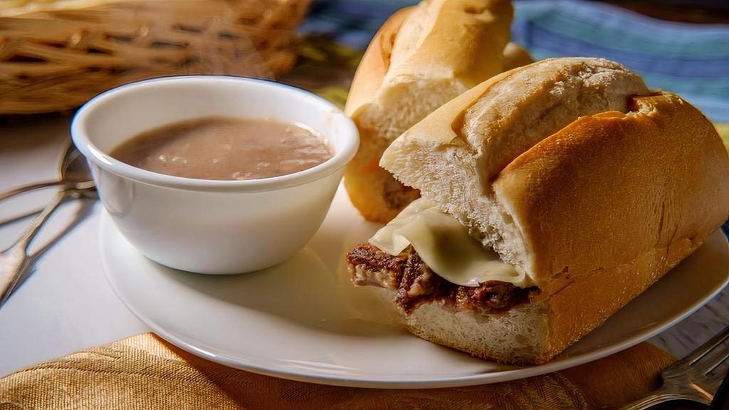French Dip · Thinly sliced Roast Beef topped with swiss & baked on a Italian loaf. Served with a side of Au & one side dish.