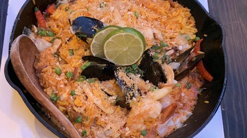 Seafood Paella · Chef's choice. Saffron infused rice, calamari, mussels, shrimp, clams, tilapia, green onions, red peppers, onions, green peas, Parmesan. Topped with panko bread crumbs.