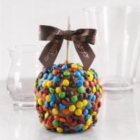 M&M · A jumbo granny smith apple hand dipped in our homemade caramel, and then rolled in mini M&Ms.