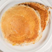 Buttermilk Pancakes · Three fluffy buttermilk pancakes. Served with whipped butter, powdered sugar, and maple syru...