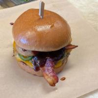 Cowboy Burger · Bacon, cheddar, onion ring, grilled jalapeños, and BBQ sauce.