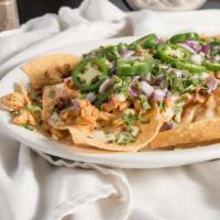 Nachos Del Rey · Grilled chicken, chorizo, queso, salsa verde, cilantro, onion, fresh jalapeño slices.