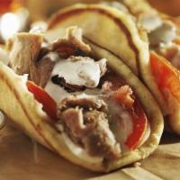 Gyro Sandwich With Fries · Fine sliced Gyros Comes on the top of a Toasted Greek pita with slices of onions, tomato, an...