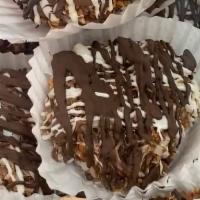 Caramel Coconut Chocolate Haystack · A shortbread cookie dipped in our Homemade Caramel, rolled in toasted coconut and drizzled w...