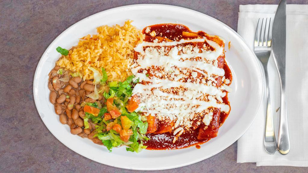 Enchiladas · Fried tortillas stuffed with choice of meat and topped with cheese, sour cream, and choice of salsa. Served with  rice, beans & salad.