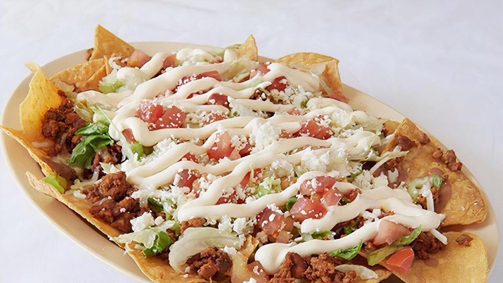 Nachos Poblanos · Beans, lettuce, tomatoes, cheese, sour cream & choice of meat.