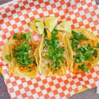 Taco · Corn tortilla, with cilantro, onions & choice of meat.