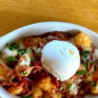 Loaded Tater Tots · Queso sauce, bacon, green onions and sour cream.