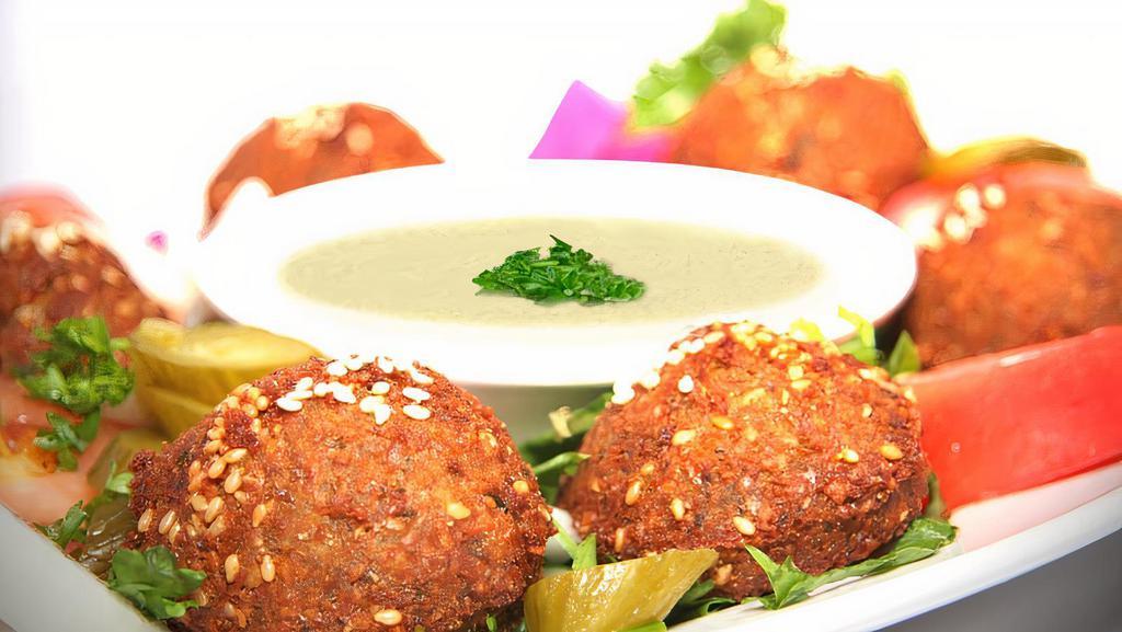 Falafel Plate · Lightly fried patties made from chickpeas, fava beans, and spices. Served with veggies and tahini sauce.