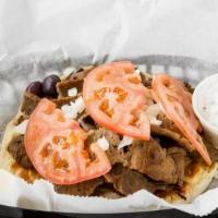 Gyro Sandwich · Pita, gyro meat, raw onions, tomatoes, feta cheese, olives, and a side of gyro sauce.
