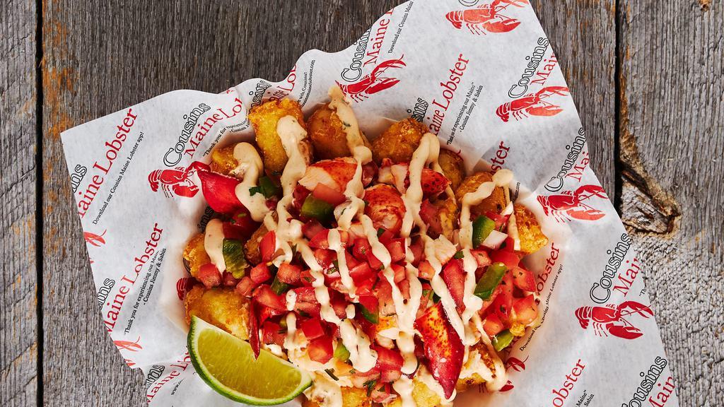 Lobster Tots · Tater tots served with warmed Maine lobster, cilantro lime sauce, and pico de gallo.
