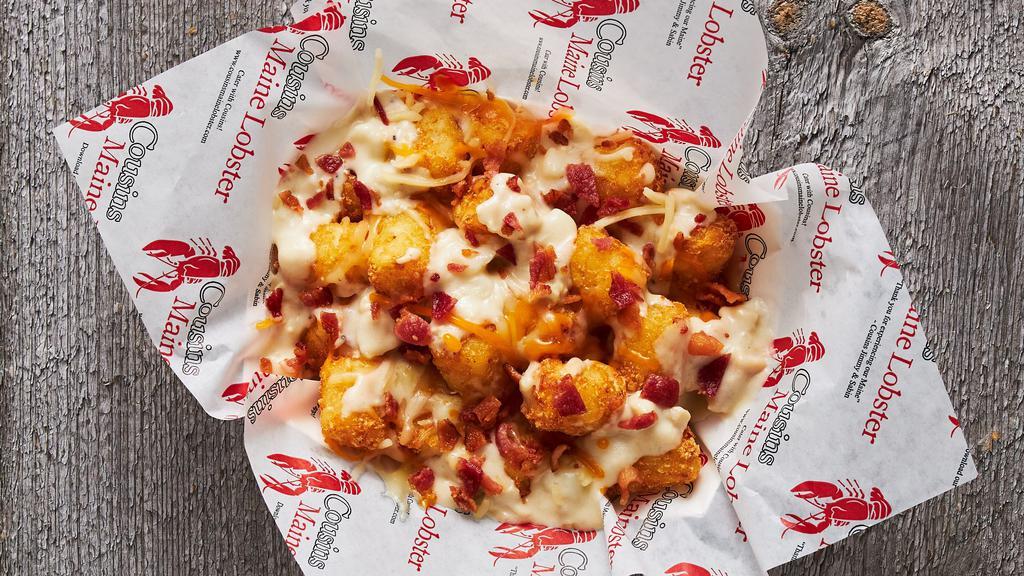 Chowder Tots · Tater tots smothered in New England clam chowder, shredded cheese, and bacon.