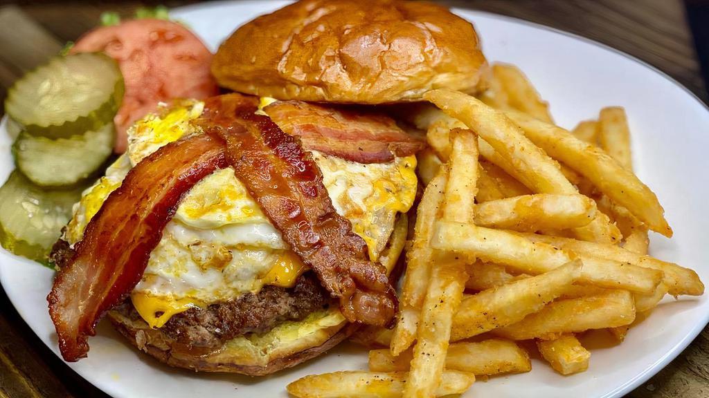 *Hangover Burger · Topped with bacon, american cheese, a fried egg, and caramelized onions, lettuce, tomato and pickle on a Brioche Bun.