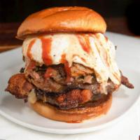 Meatasaurus Rex · Stuffed: Cheddar. Topped: Pulled Pork Belly, Bacon, Cage Free Fried Egg, Hickory Smoked. Bee...