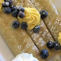Lemoncello Crepe · Stuffed with limoncello, cream cheese frosting, fresh blueberries, and topped with limoncell...